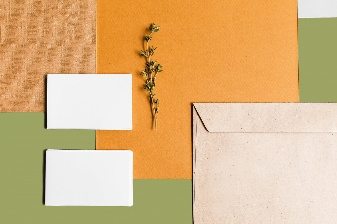 Business Cards and Paper on Green Background